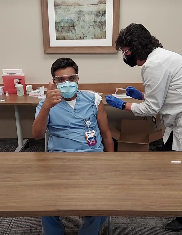 Photo of Dr. Tirupathi receiving the vaccine